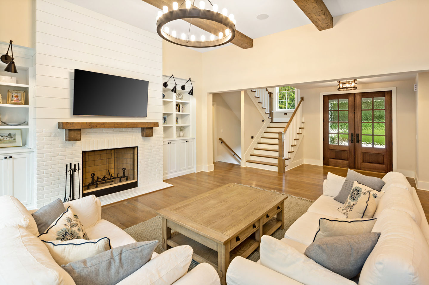 Cozy living room with fireplace and wooden beams.