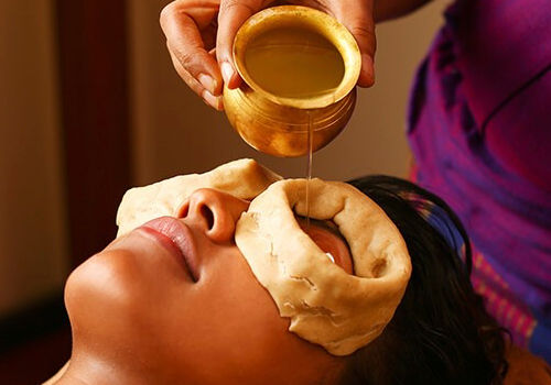 Eye treatment with oil poured over dough rings