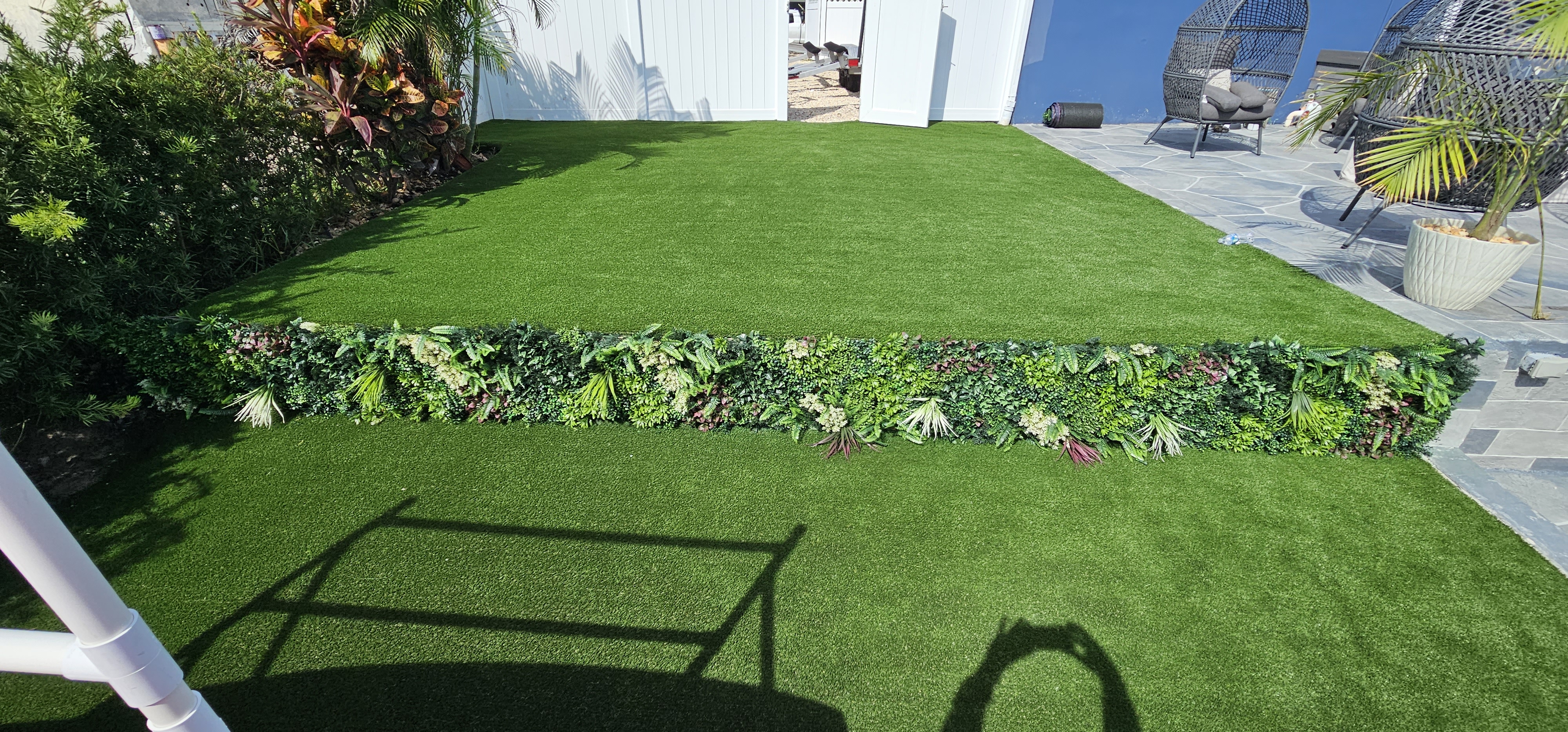 Artificial turf installed beside a home, landscaping