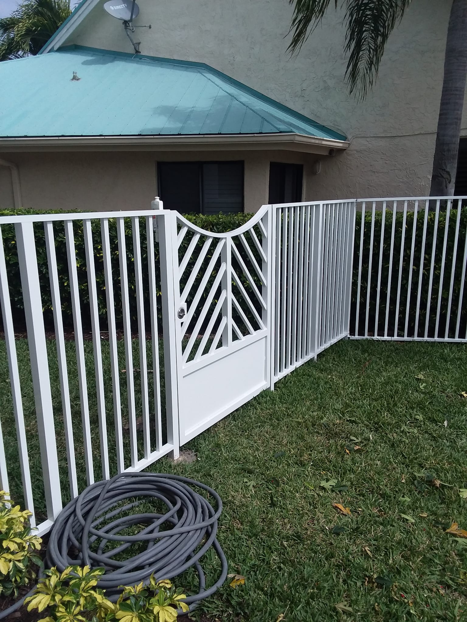 White powder-coated aluminum picket gate and fence, chevron pattern