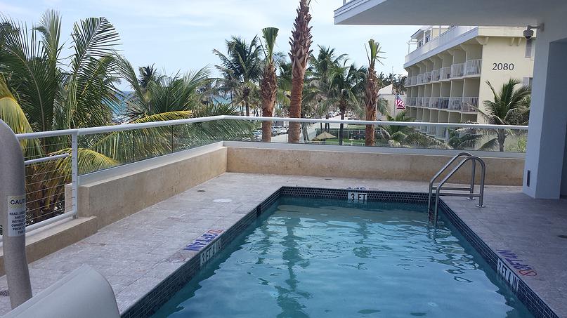 Glass railing system on a pool deck