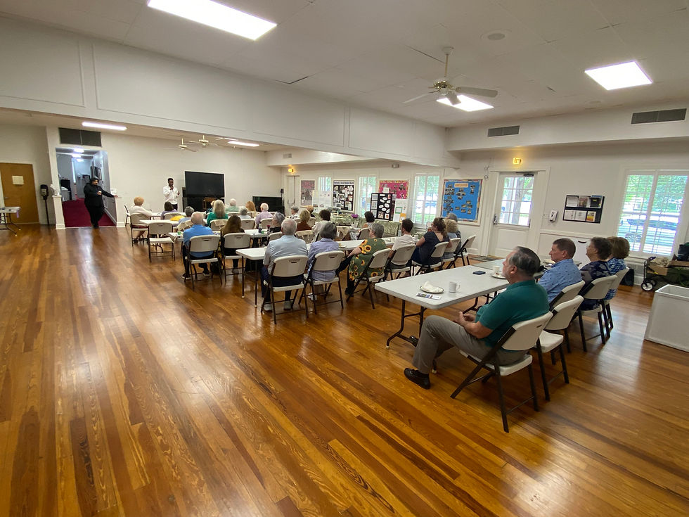 church members sitting at tables watching a presentation