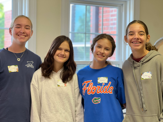 A group of young teen girls smiling