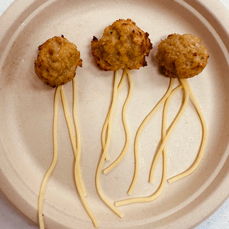meatballs and pasta on a plate made to look like squid