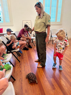 A veterinarian showing a group of children a tortoise
