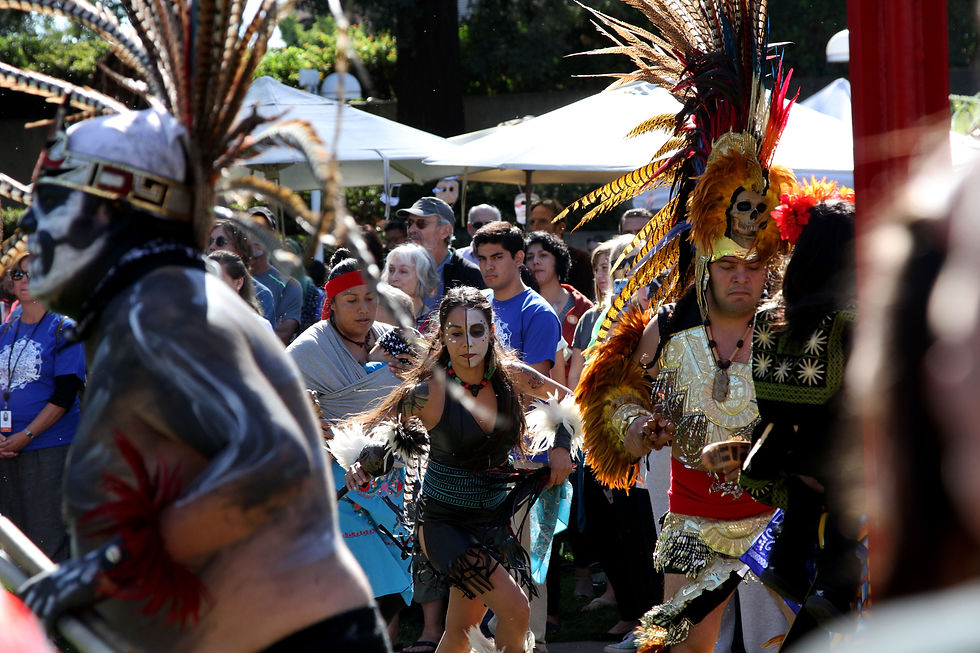 A woman dancing a traditional Aztec dance.