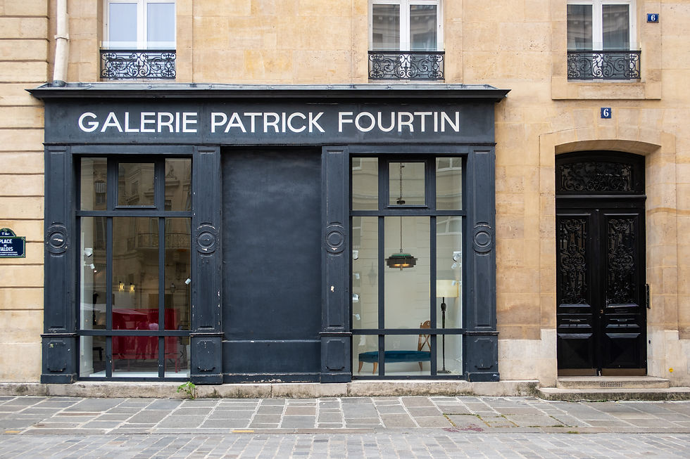 Storefront of Galerie Patrick Fourtin on a quiet Parisian street, featuring black-framed windows set within a classic cream-colored Haussmann building. The location is recognized by many fans as one of the filming sites featured in Emily in Paris.