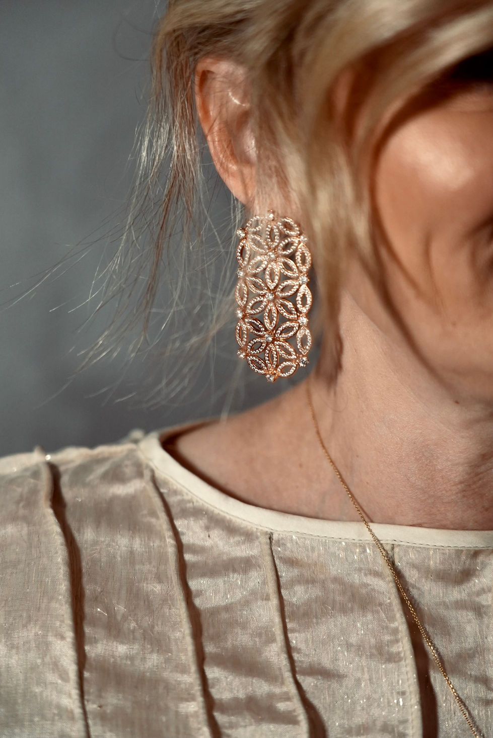 Detail of a Franco Jewellers filigree drop earring against a MASTANI pleated shoulder in Melbourne, Australia, creative direction and styling by Tamarra McNaught, founder of TITO STYLE