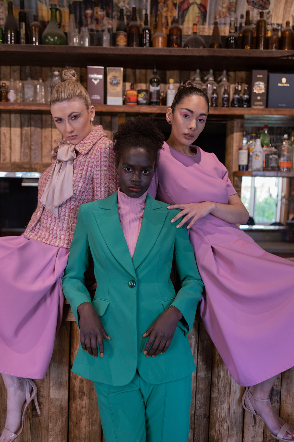 A green suit and a pink look paired at the estate bar. Moss & Spy looks, with creative direction and styling by Tamarra McNaught, founder of TITO STYLE, at Riverlea Estate, Warrandyte, Victoria, Australia.