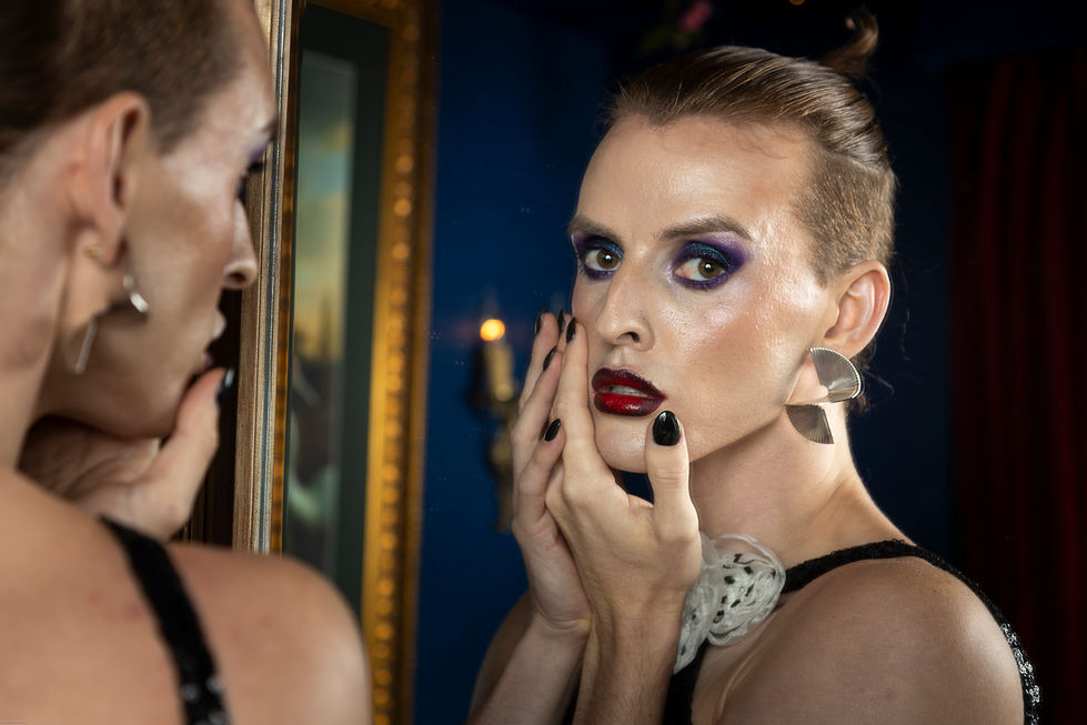 Adam Noviello reflected in a gilt mirror in dramatic editorial makeup, styled by TITO STYLE