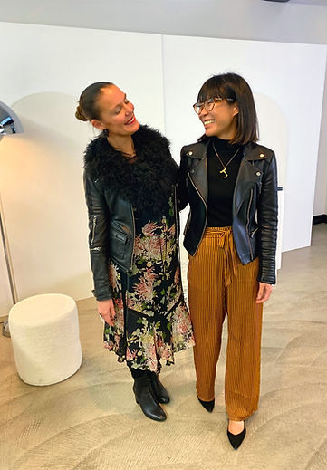 Tamarra McNaught, Fashion & Celebrity Stylist and founder of TITO STYLE, based in Melbourne, Australia, smiling with a client, both wearing stylish leather jackets; Tamarra styled in a floral dress and boots, client in mustard striped trousers and heels, showcasing personalised styling and joyful connection