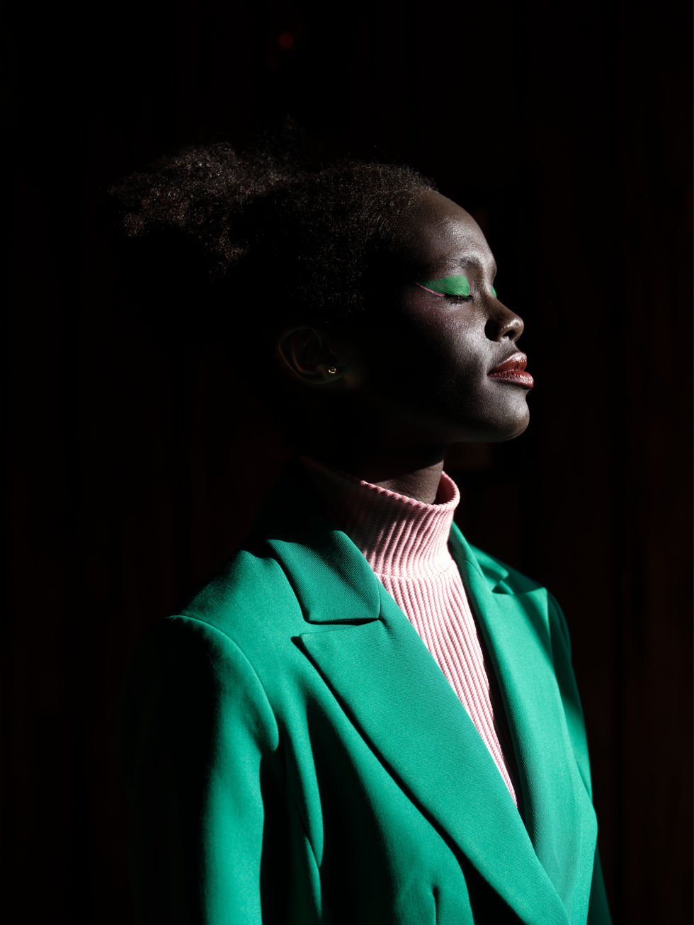 A green blazer and pink turtleneck in a dramatic shadowed profile. A Moss & Spy look, with creative direction and styling by Tamarra McNaught, founder of TITO STYLE, at Riverlea Estate, Warrandyte, Victoria, Australia.