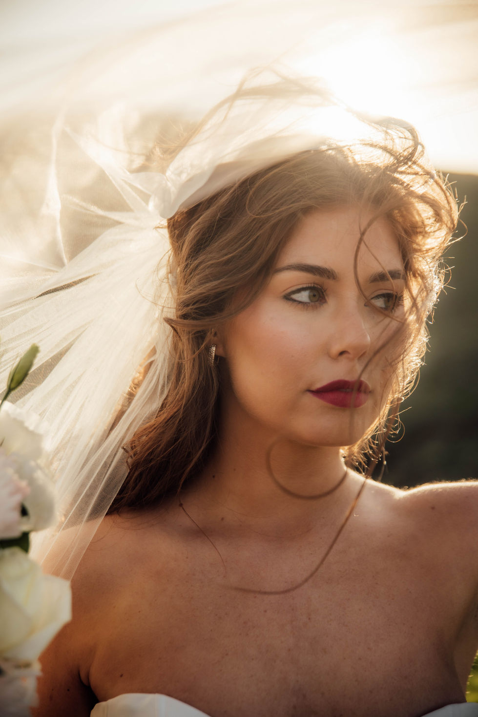 A bride in a sheer veil, shot close in soft light. A gown by The Sposa Group, styling by Tamarra McNaught, founder of TITO STYLE, at Cairn Beach, Australia.
