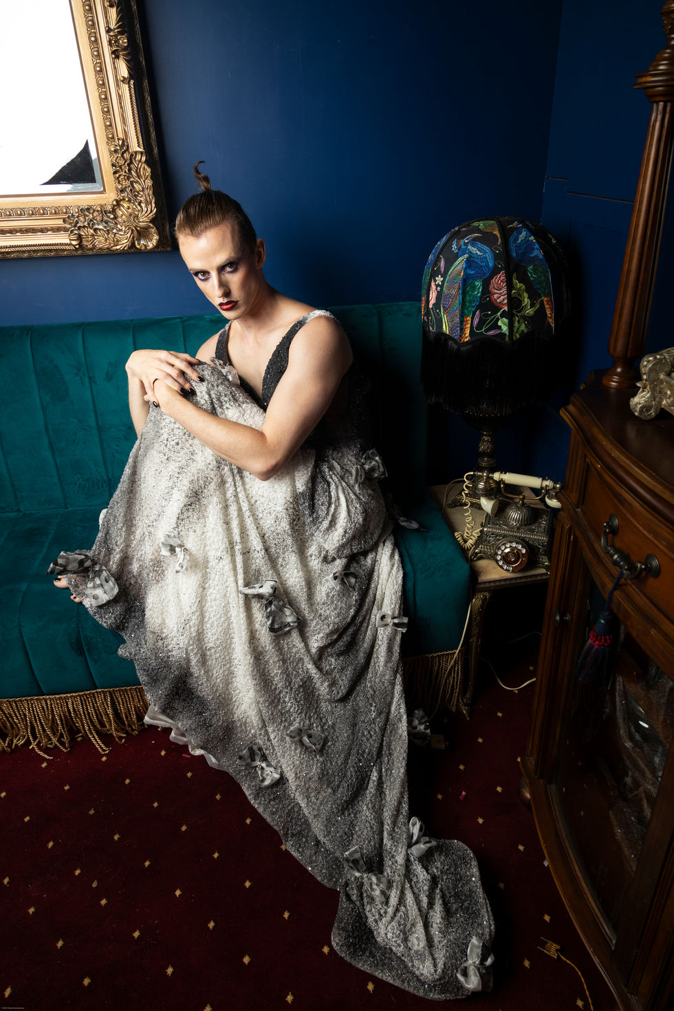 Adam Noviello in a silver gown seated among gilt frames, TITO STYLE editorial, Melbourne heritage interior