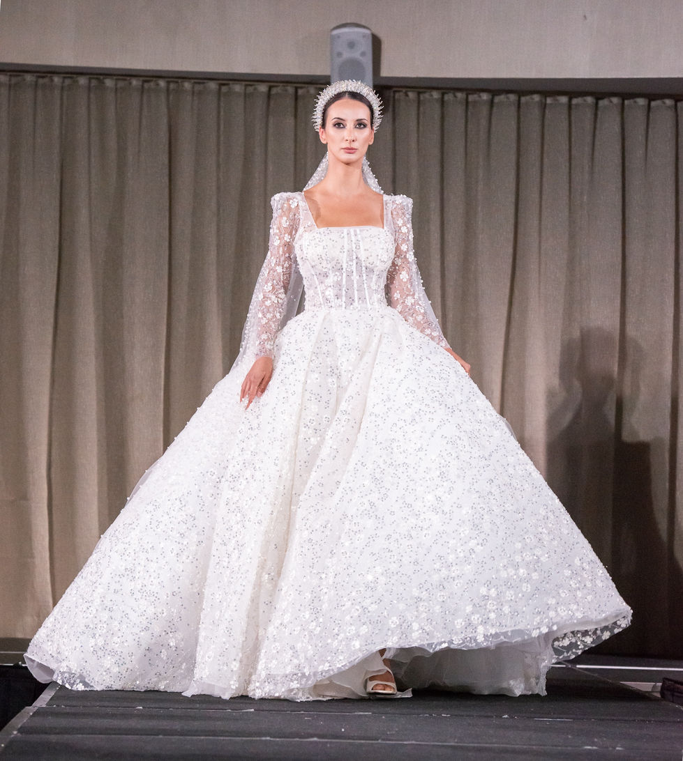A white ballgown with long sleeves and a square neckline. A Jullia Bridal Couture gown, with creative direction and styling by Tamarra McNaught, founder of TITO STYLE, at The Hotel Windsor, Melbourne, Australia.