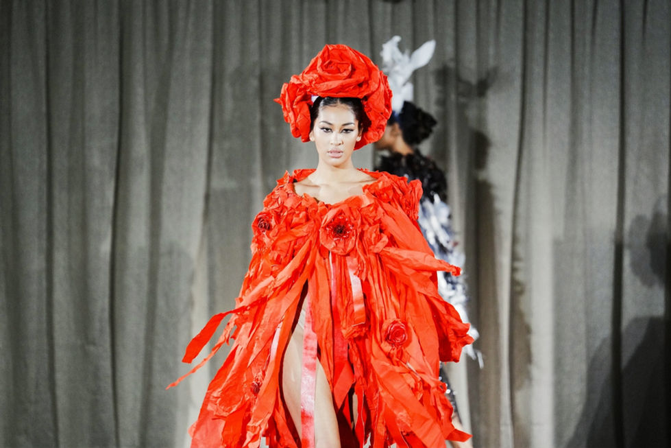 A dramatic orange gown with a red rose headpiece and sheer red panels. A Curl Paper look, with creative direction and styling by Tamarra McNaught, founder of TITO STYLE, at The Hotel Windsor, Melbourne, Australia.