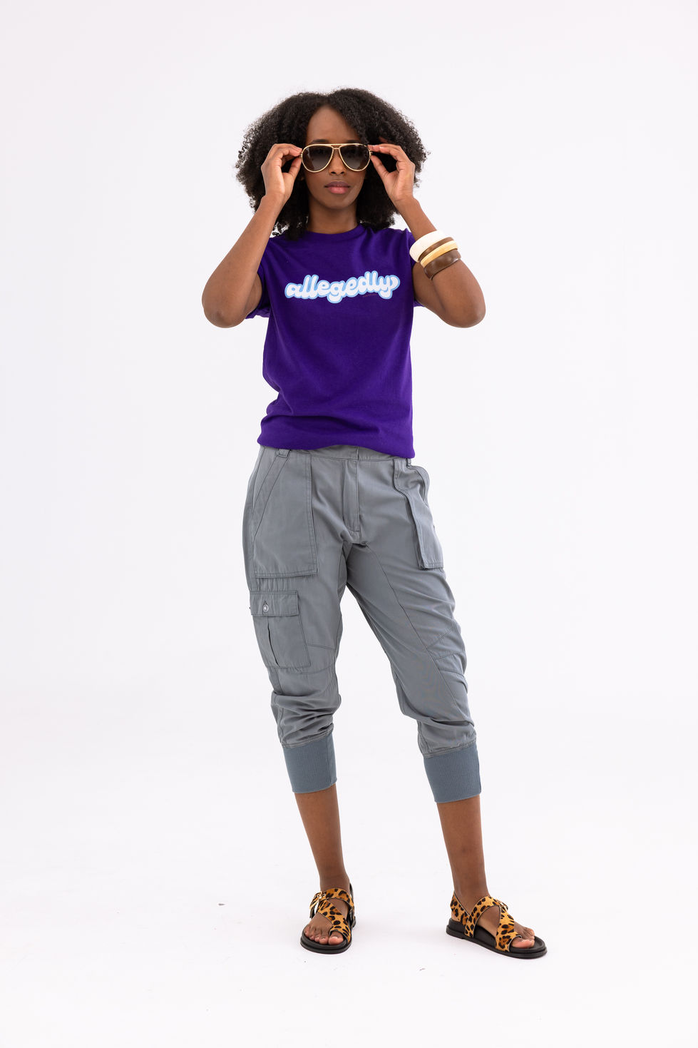 Purple The Red Heart Campaign slogan tee with grey cargo pants, aviators and leopard Edward Meller sandals in Melbourne, Australia, creative direction and styling by Tamarra McNaught, founder of TITO STYLE