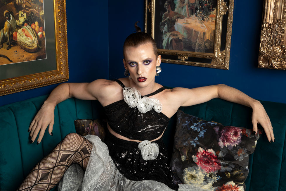 Adam Noviello in black embellished couture on a floral sofa, TITO STYLE editorial for Foreign Influence TV