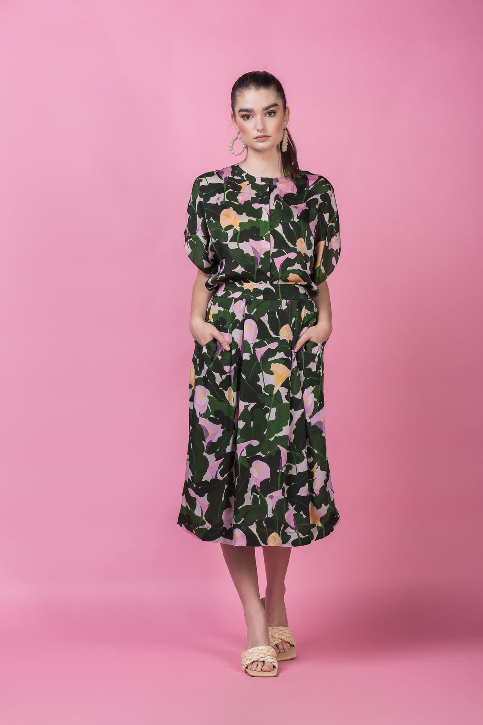 Devoi dark green calla lily print top and skirt set against a pink backdrop in Melbourne, Australia, styling by Tamarra McNaught, founder of TITO STYLE