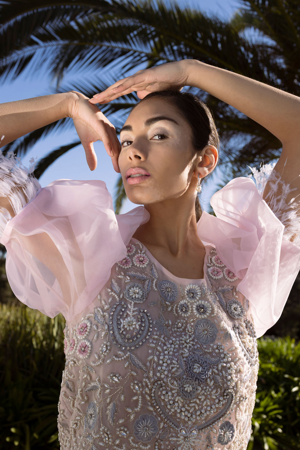 An ivory embellished gown with sheer detailing, hands framing the face in soft daylight. A Tanya Didenko Couture gown, with creative direction and styling by Tamarra McNaught, founder of TITO STYLE, at Riverlea Estate, Warrandyte, Victoria, Australia.