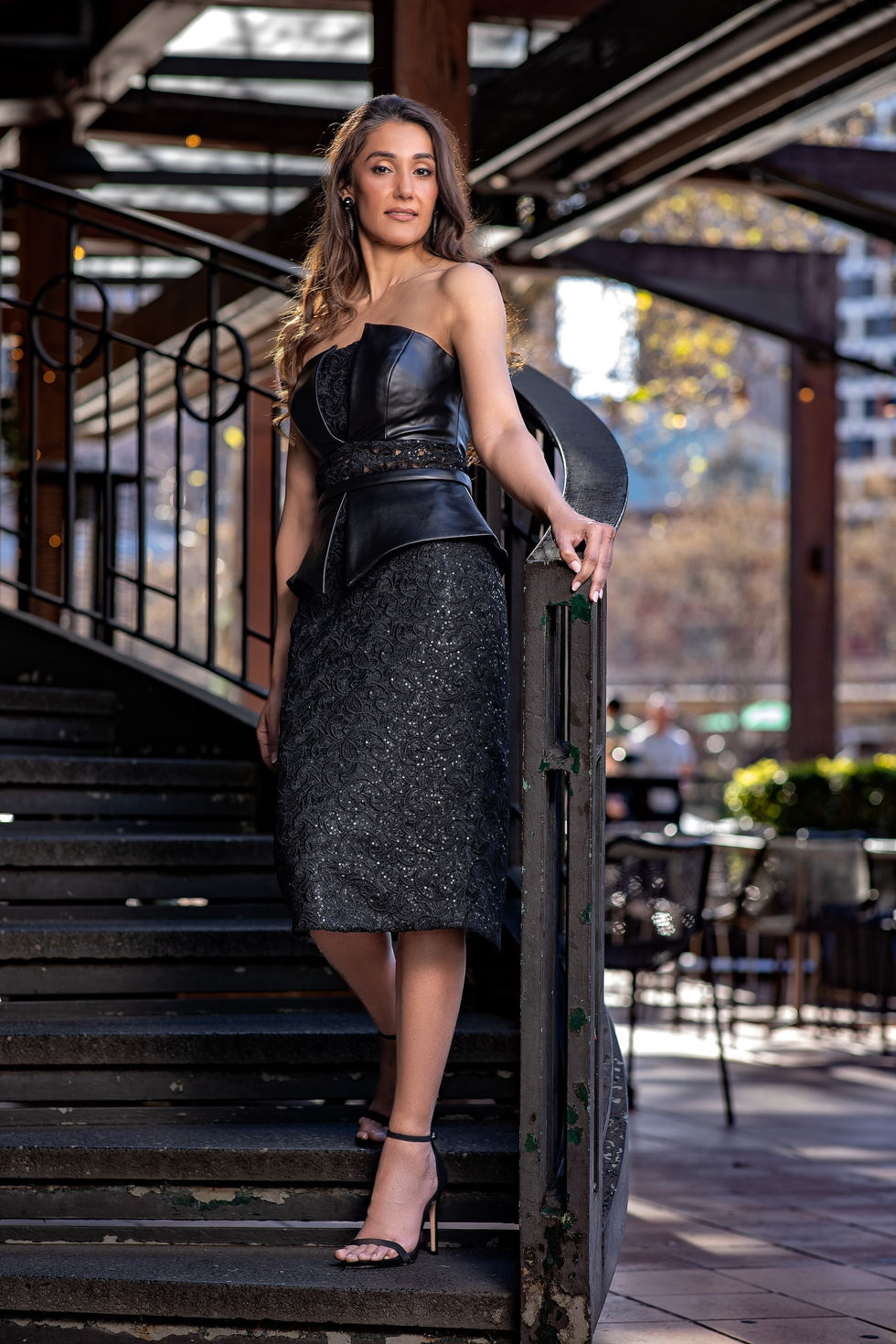 Model in a black Katayoon Mabel leather peplum and sequinned skirt on a spiral staircase at Southbank, Melbourne, Australia; creative direction and styling by Tamarra McNaught, founder of TITO STYLE.