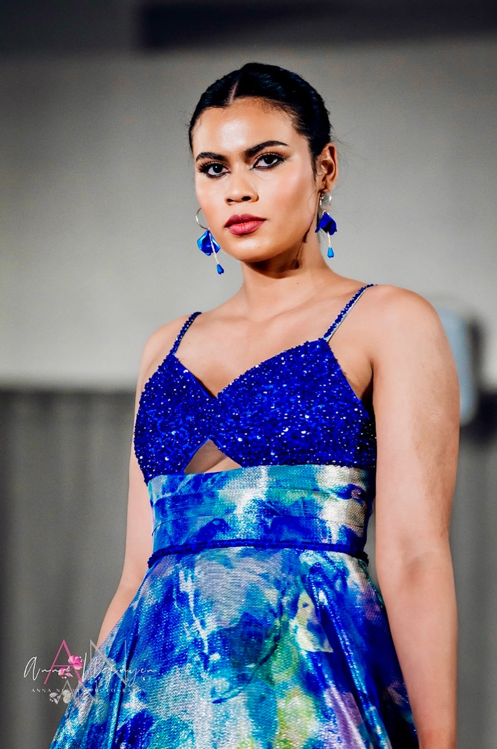A blue sequinned gown with a cut-out waist and blue drop earrings. A Katayoon Mable look, with creative direction and styling by Tamarra McNaught, founder of TITO STYLE, at The Hotel Windsor, Melbourne, Australia.
