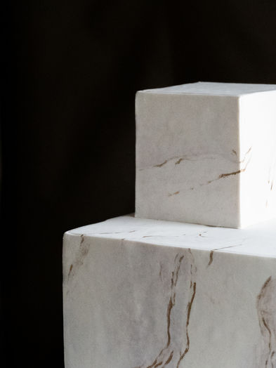 A sculptural wedding cake from The Marble collection featuring elevated stone-inspired textures and soft earthy tones for a clean, modern aesthetic.