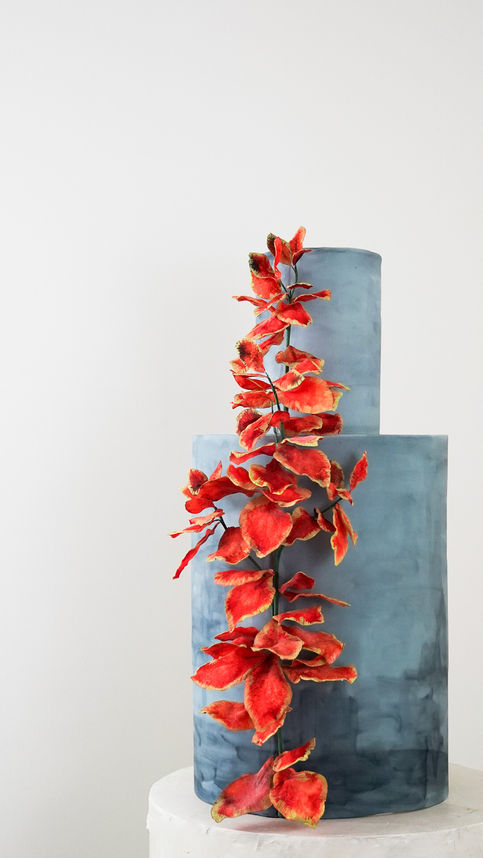 2-Tier Custom Celebration Cake inspired by Van Gogh's "Coleus Plant in a Flower Pot". Dark blue cake tiers with bright orange leaf foliage accent.