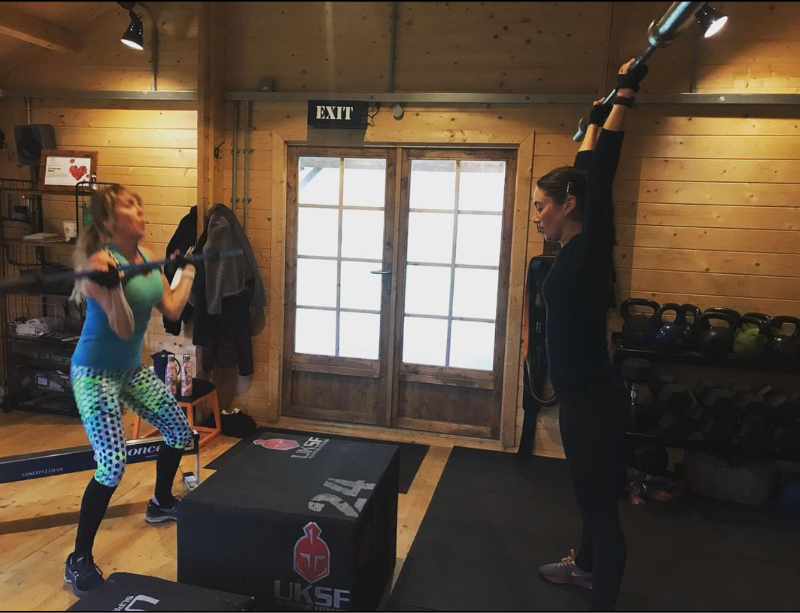 Two ladies exercising with weights