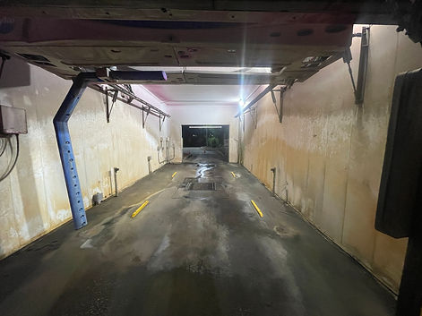 Before commercial pressure washing of car wash with stained walls and floors in Tampa Bay FL by Environmental Pressure Washing