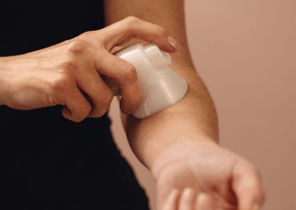 mulher aplicando reposição de estradiol em spray no braço