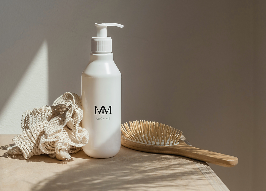 Cosmetic bottle with a pump beside the brush and sponge_Logo jabon sin fondo.png