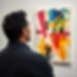 I need an image of a good looking Indian man looking at an abstract painting.jpg
