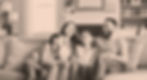 Family of four sitting together on a couch representing financial security from affordable life insurance.