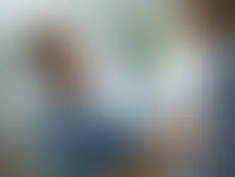 Family member holding a patient's hand in a hospital room, representing financial protection through hospital indemnity insurance.