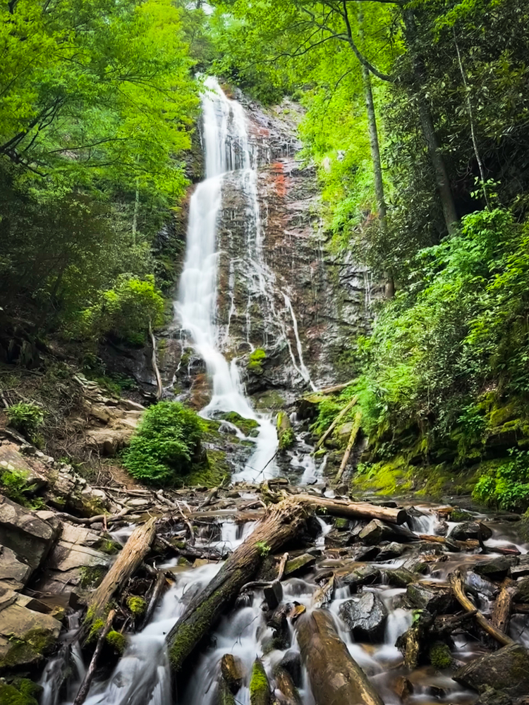A large waterfall pours over rock