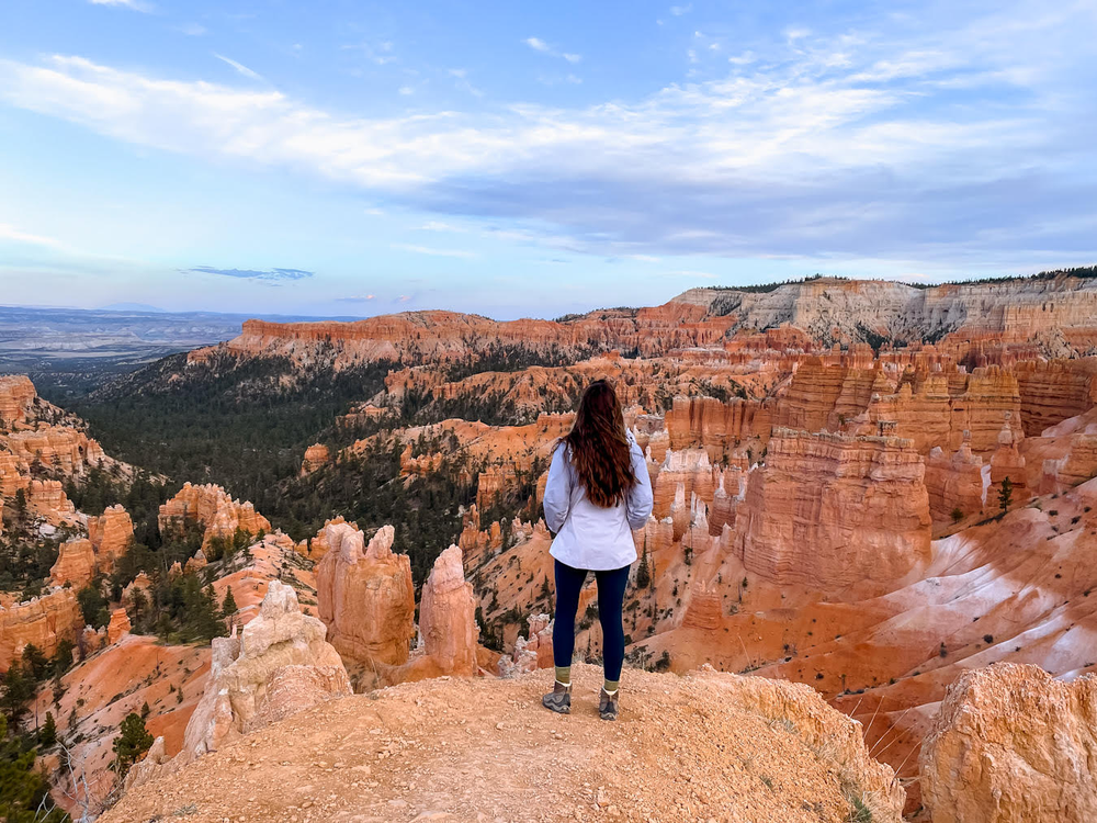 A woman overlooks red rock formations at Bryce Canyon National Park 
