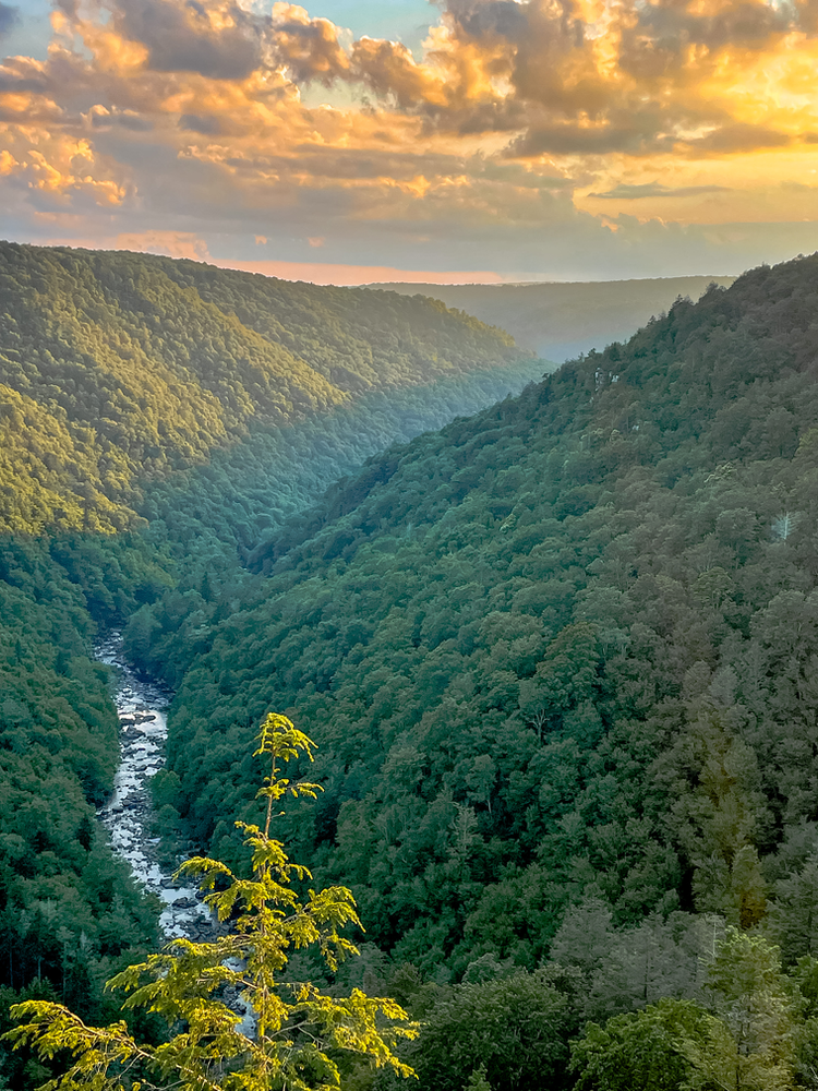 Sunset in the valley with a river flowing below