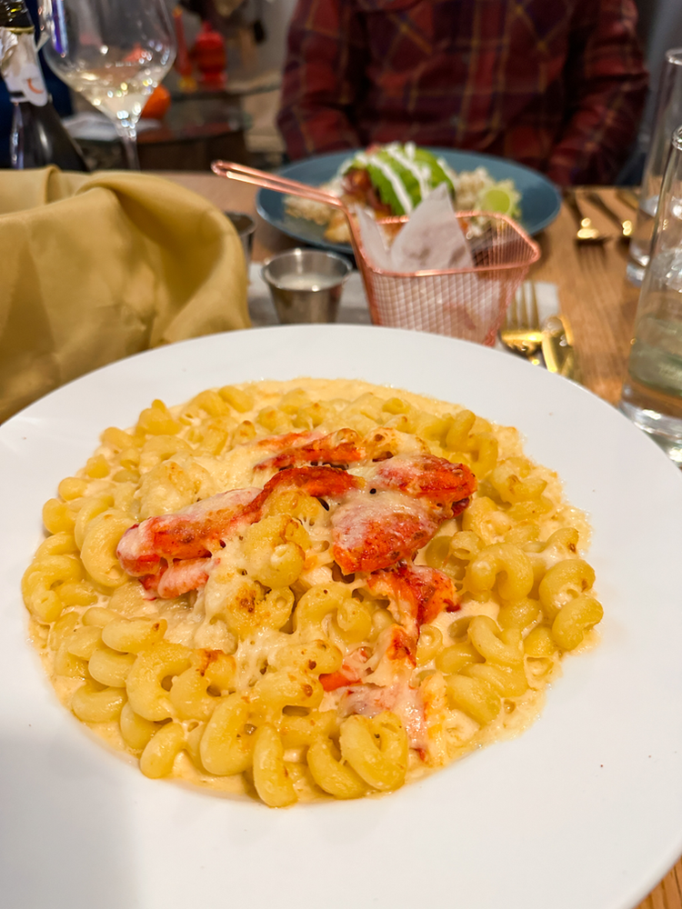 A dish of macaroni and cheese with lobster on top