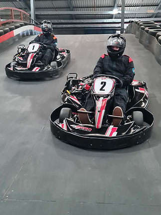 Two go-karts lined up on a race track