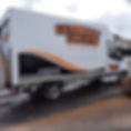 A white van branded "Ultimate Uplifts" with contact info