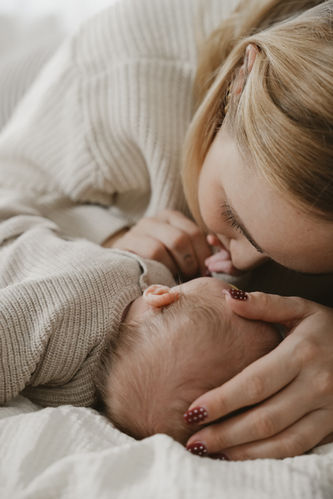Baby-Fotoshooting Detailaufnahme – Sanfter Kuss auf die Stirn eines Neugeborenen im Atelier Achatz.