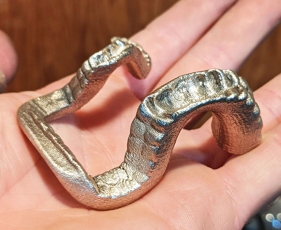Bronze 3d printed phone stand polished up