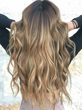 Dirty blonde with beautiful waves showing off her hair color.