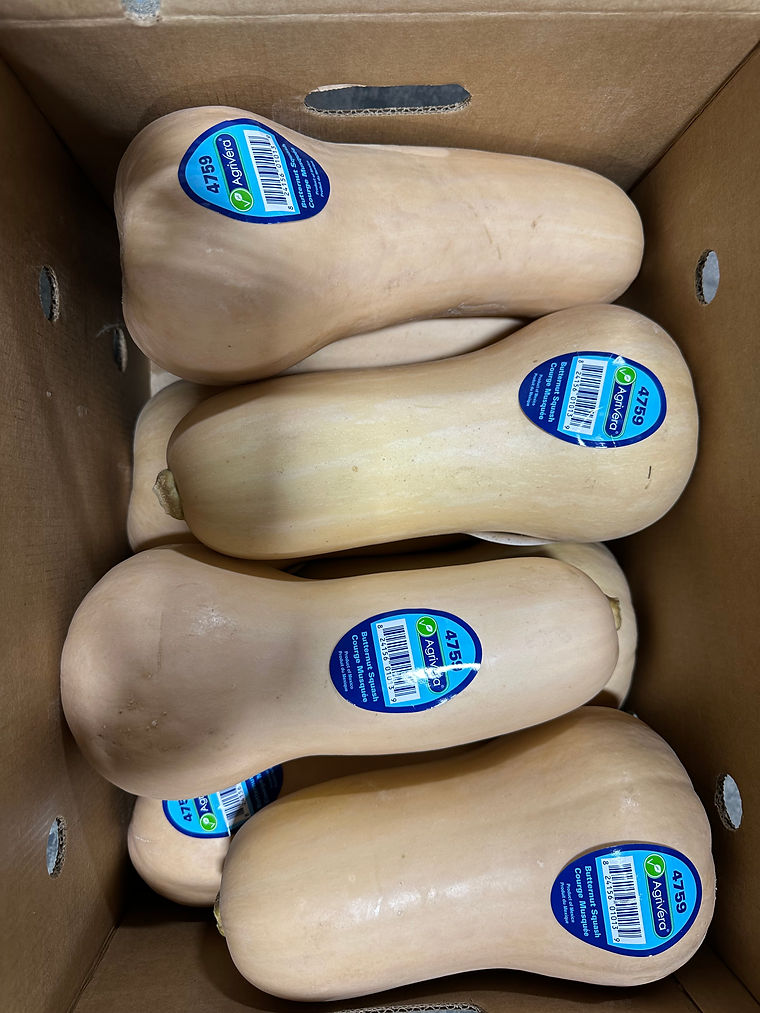 Butternut squash with PLU stickers, stacked for packing