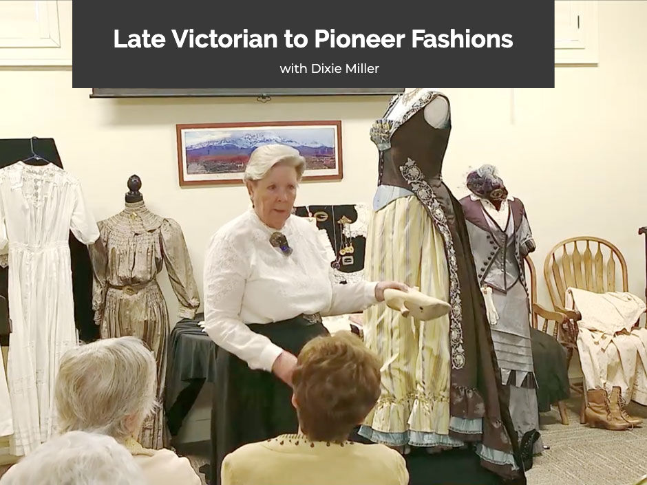 Dixie Miller holding a Victorian-era shoe while presenting on Victorian and pioneer fashions at the McQuarrie Memorial Pioneer Museum.