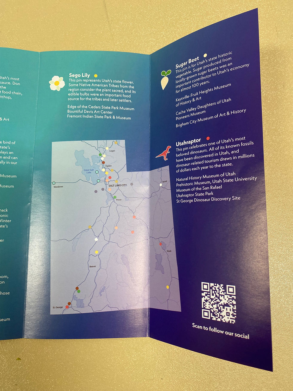 Brochure panels featuring three Utah Pin Quest pins and a map of participating museums statewide.