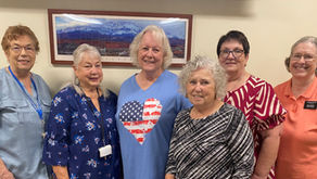 Group photo of the six volunteer staff members of the McQuarrie Memorial Museum standing together inside the museum.