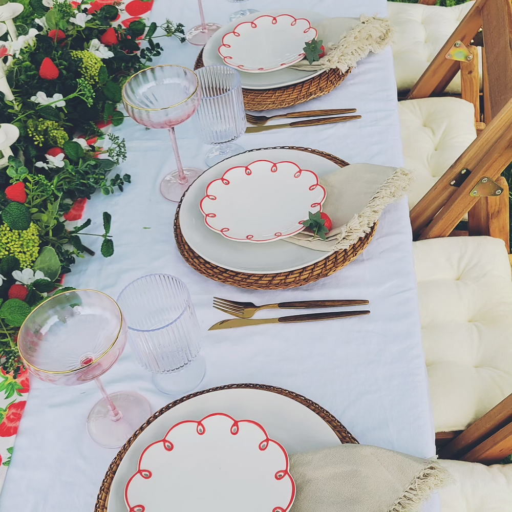 Wedding table setting with red chargers and green napkins styled by MickNics Maryland