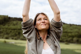 DSC08958.jpgFrau streckt im Freien die Arme nach oben – symbolisiert Öffnung, Körperwahrnehmung und natürliche Ressourcenstär